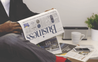 Reading finances in newspaper