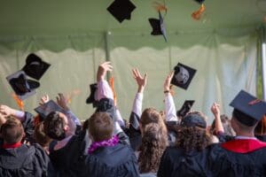 Graduation celebration with graduates throwing caps in the air