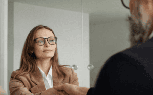 Divorced woman shaking a financial advisor's hand