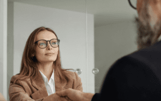 Divorced woman shaking a financial advisor's hand